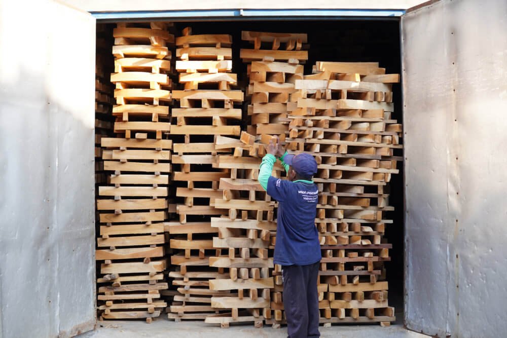 Kiln drying timber boards arranged at Indonesian furniture factory